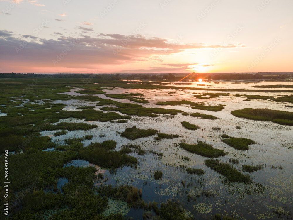 Aerial panoramic sunset sunrise scene at swamps and wetlands of Big Creek National Wildlife Area near Long Point Provincial Park, Lake Erie shore. Aerial panoramic sunset sunrise scene at swamps and wetlands of Big Creek National Wildlife Area near Long Point Provincial Park, Lake Erie shore.