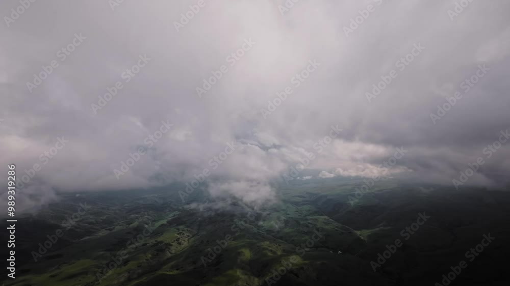 4K aerial view of mountains and green hills, beautiful clouds in the mountains at high altitude. Nebula descends to the ground, drone flight in the clouds 4K aerial view of mountains and green hills, beautiful clouds in the mountains at high altitude. Nebula descends to the ground, drone flight in the clouds