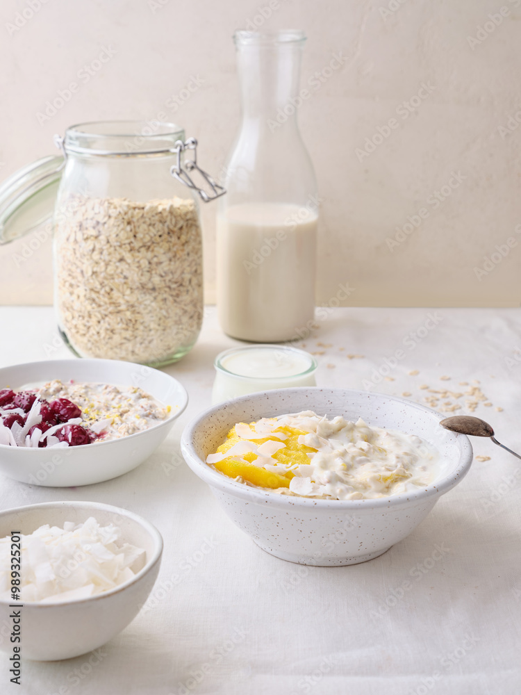 Overnight oats with mango and coconut topping. Fitness healthy breakfast in a bowl Overnight oats with mango and coconut topping. Fitness healthy breakfast in a bowl