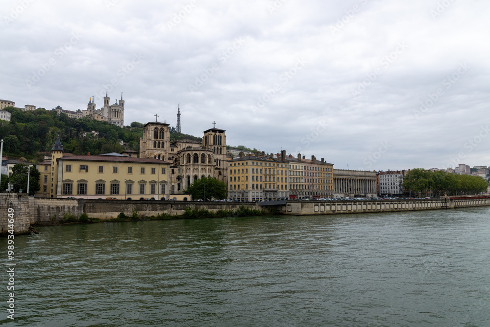 Fototapeta premium Lyon with a view over the Saone to the church Notre Dame in rainy weather in spring