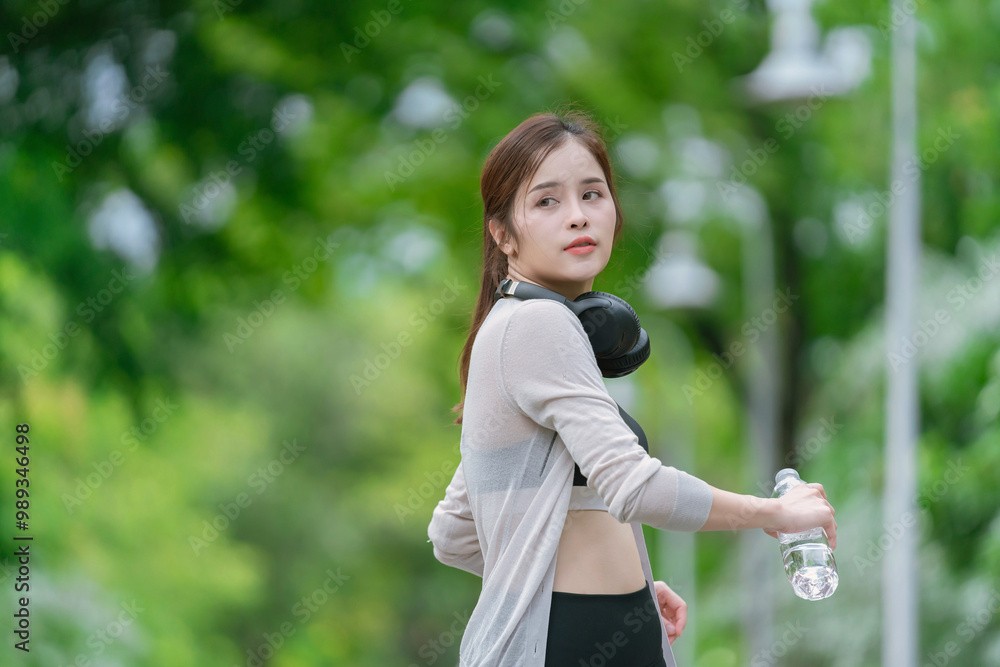 Smiling Asian woman doing sport exercises running jogging in morning park, skinny fit in sports wear outfit leggings. fitness woman running around in the park. Smiling Asian woman doing sport exercises running jogging in morning park, skinny fit in sports wear outfit leggings. fitness woman running around in the park.