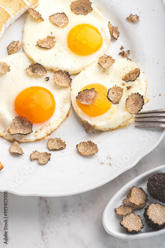 Black truffles gourmet  breakfast, brunch. Fried eggs recipe with black truffles and toast bread , white background. Internet banner, top view. Healthy recipe of Piedmont, Italy, Spain and France