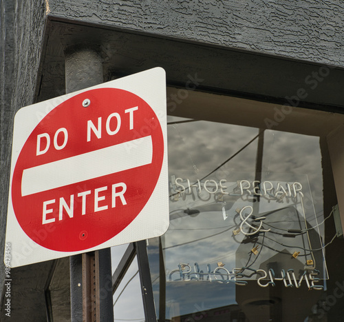 Do Not Enter sign in front of a closed shoe repair store USA 2024 