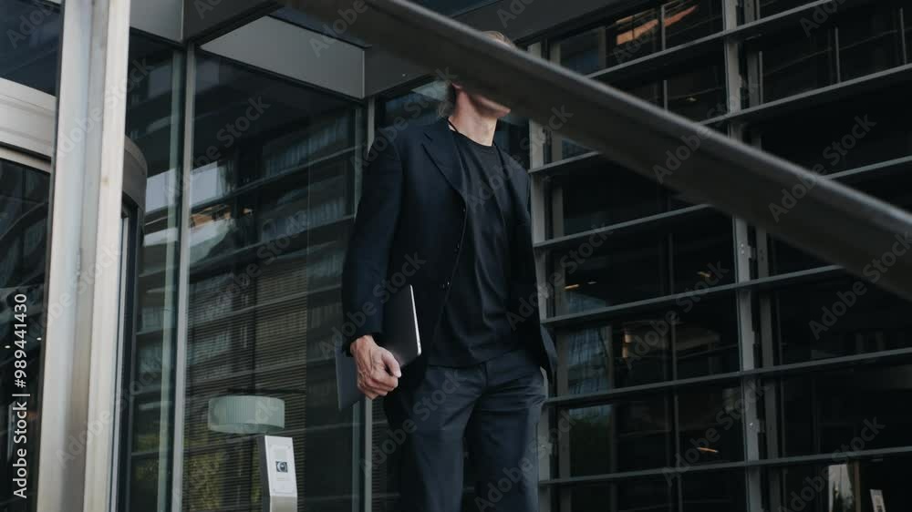 Man businessman boss walking near his office center in a dark business suit, Experienced CEO entrepreneur in modern office district Man businessman boss walking near his office center in a dark business suit, Experienced CEO entrepreneur in modern office district
