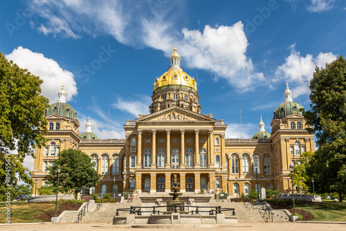 The Iowa state Capitol building on a hot late summer day with blue skies and clouds.  Des Moines, Iowa, USA.
