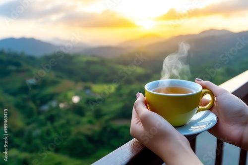 A person sipping hot tea on a balcony, overlooking a serene landscape, starting the day with mindfulness photo