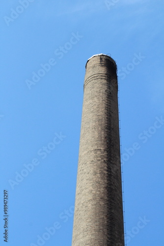 Two Big chimneys in factory against blue sky background 