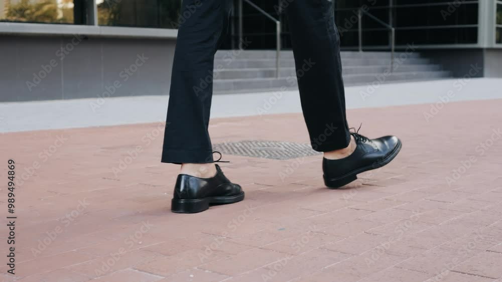 Man businessman boss walking near his office center in a dark business suit, Experienced CEO entrepreneur in modern office district Man businessman boss walking near his office center in a dark business suit, Experienced CEO entrepreneur in modern office district