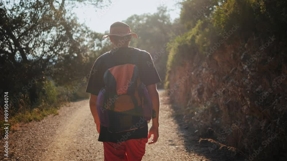 Man walking in park, hiker adventurer enjoys hiking a scenic trail near majestic mountains. Tourist male walk outdoor in forest, Spain, Barcelona. Man walking in park, hiker adventurer enjoys hiking a scenic trail near majestic mountains. Tourist male walk outdoor in forest, Spain, Barcelona.