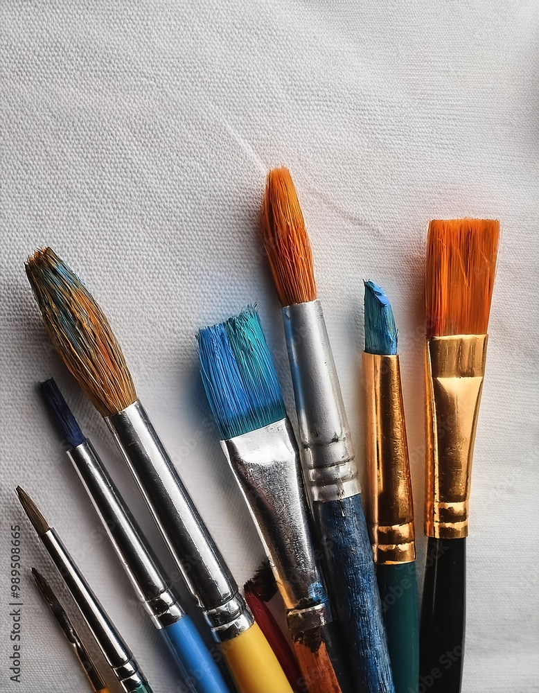 Fototapeta premium Paint and brushes lie on a white canvas. Creative Activities