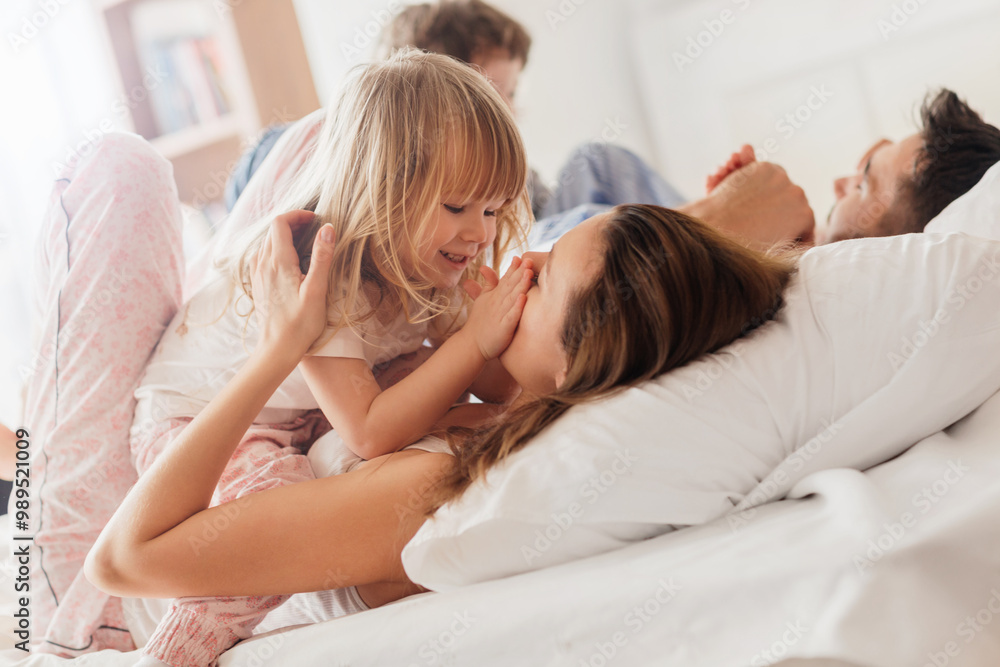 Happy family playing together on bed in the morning Happy family playing together on bed in the morning