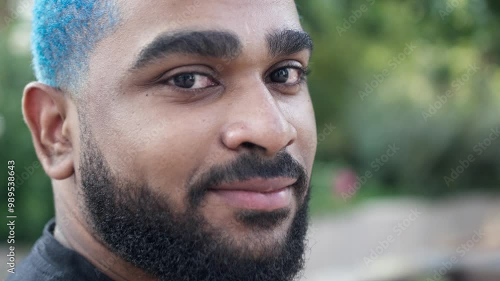Close-up of african american young man with blue hair looking confident at camera.MOV Close-up of african american young man with blue hair looking confident at camera.MOV