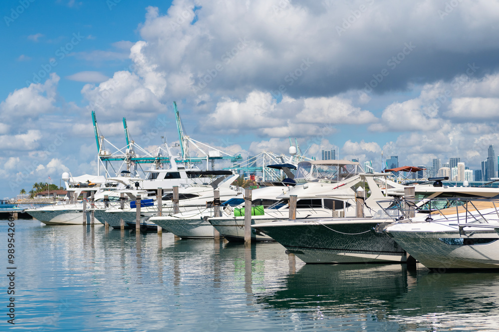 Fototapeta premium Luxurious yacht in Miami beach. Marina in Miami Beach, Florida. Luxury South beach marina. Miami downtown marina with impressive yacht and boat. Luxury yacht moored on Lauderdale canal