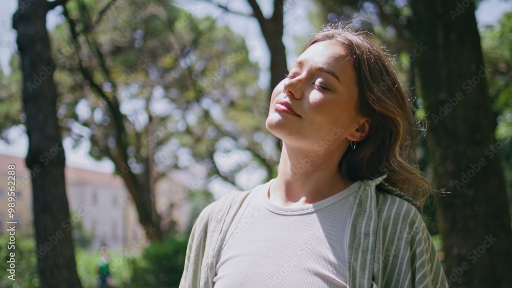 Carefree girl basking sunlight closing eyes at nature closeup. Beautiful woman Carefree girl basking sunlight closing eyes at nature closeup. Beautiful woman