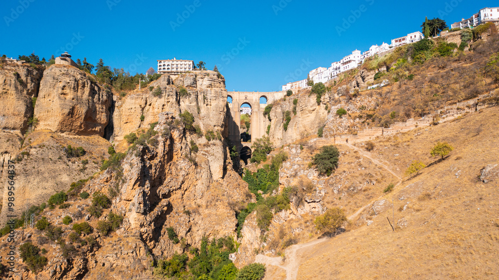 Aerial photo from drone to Puente Nuevo (The New Bridge) over Guadalevin River in Ronda medieval town sunset. Ronda, Andalusia, Spain. Aerial photo from drone to Puente Nuevo (The New Bridge) over Guadalevin River in Ronda medieval town sunset. Ronda, Andalusia, Spain.