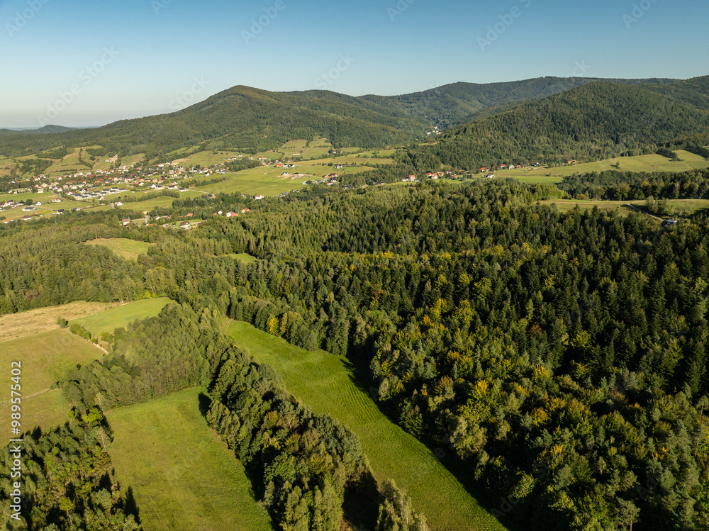 Fototapeta premium Beskid Maly aerial panorama of potrojna hill and czarny gron.Little Beskids mountain range in summer.Aerial drone view of Rzyki Village in Beskid Maly Poland.Czarny gron ski resort in Rzyki.
