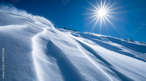 Obraz na płótnie A snowboarder dropping into a steep bowl the sun shining brightly overhead casting long shadows on the snow. w salonie