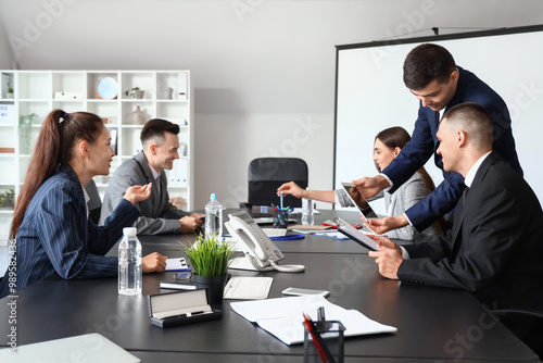 Business people negotiating at table in conference hall