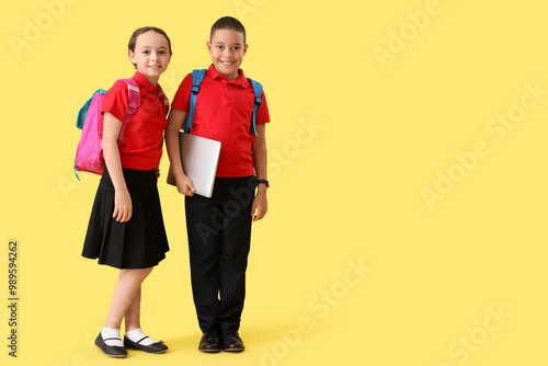 Happy little pupils with ba...