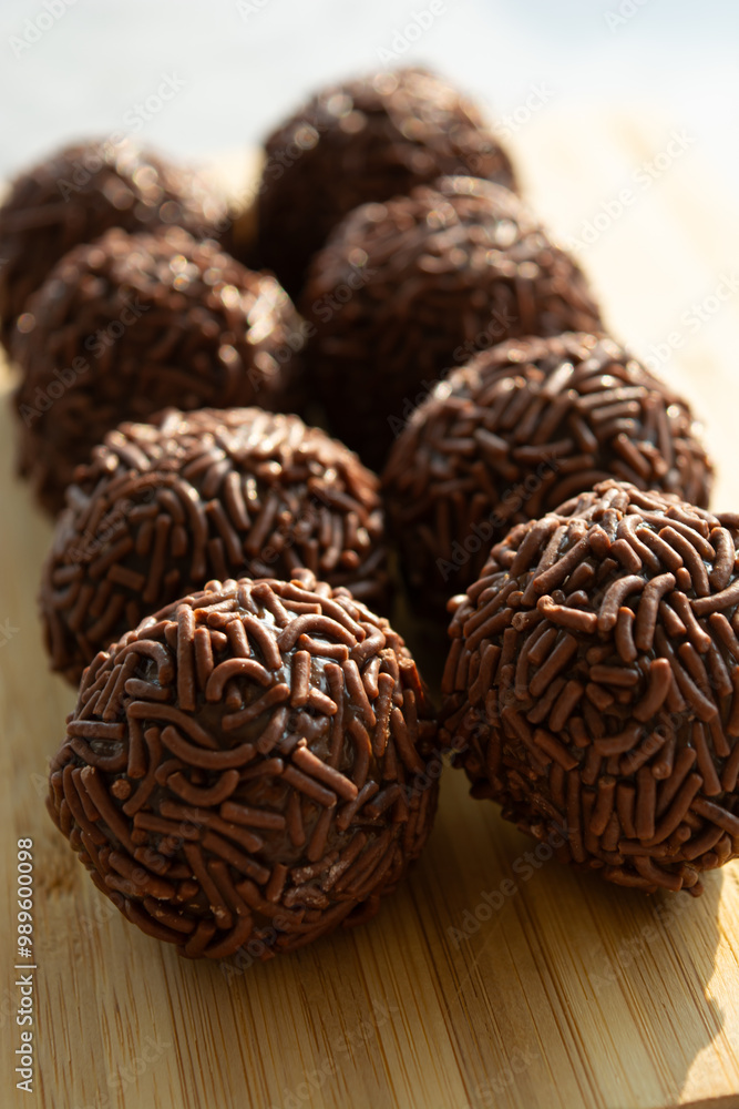 Close-up of chocolate-covered treats on a wooden board. Close-up of chocolate-covered treats on a wooden board.