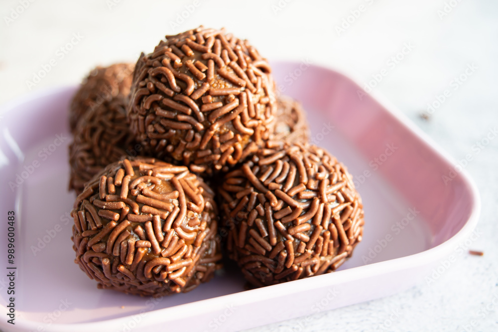 Close-up of a plate of chocolate brigadeiros, a popular Brazilian dessert. Close-up of a plate of chocolate brigadeiros, a popular Brazilian dessert.