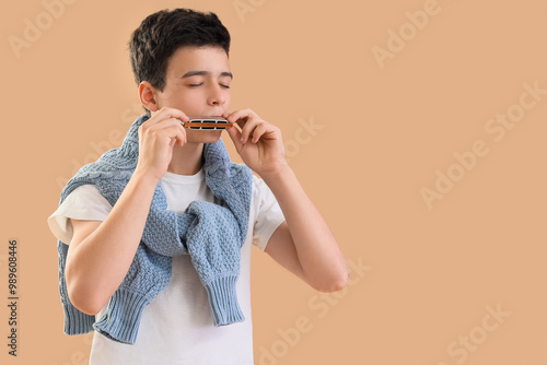 Teenage boy playing harmoni...