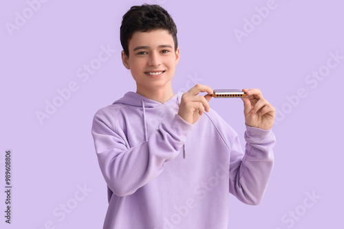 Teenage boy with harmonica ...