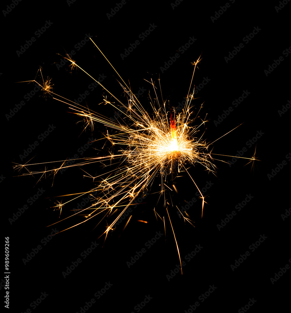 Fototapeta premium Christmas sparkler burning isolated on black background...
