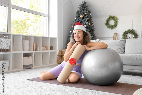 Smiling woman in santa hat ...