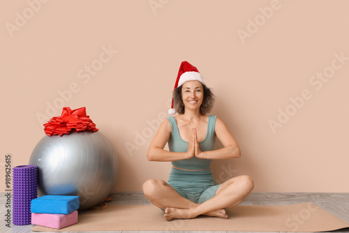Smiling woman in santa hat ...