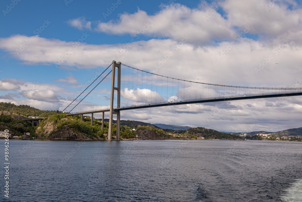 Passing Under the Askøy Suspension Bridge Across the Byfjorden, From the deck of a cruise ship leaving Bergen, Norway in Summer Passing Under the Askøy Suspension Bridge Across the Byfjorden, From the deck of a cruise ship leaving Bergen, Norway in Summer
