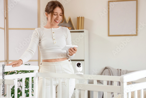 Young woman with baby monit...