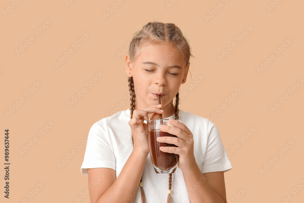 Cute girl with glass of sweet hot cocoa on brown background Cute girl with glass of sweet hot cocoa on brown background