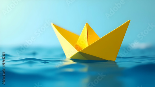 Close-Up of a Yellow Paper Boat Floating on Water Representing Creativity and Simplicity