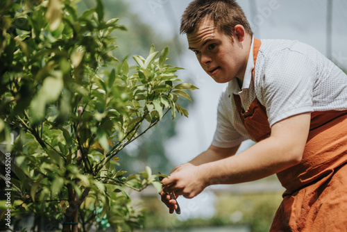 A dedicated young gardener with down syndrome carefully trims plants in a lush garden setting. His focus and passion for nature highlight inclusivity and empowerment.
