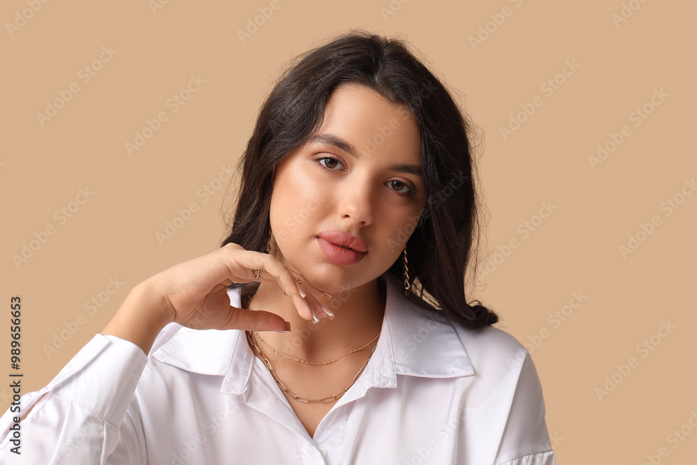 Fashionable young woman in beautiful jewelry on brown background Fashionable young woman in beautiful jewelry on brown background