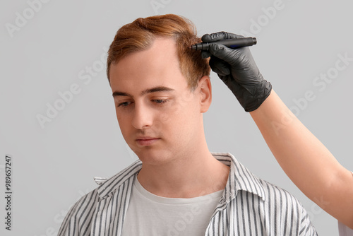 Trichologist marking young ...