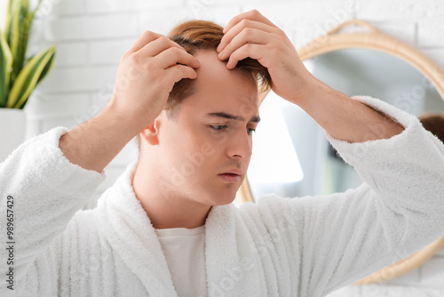 Young redhead man with hair...