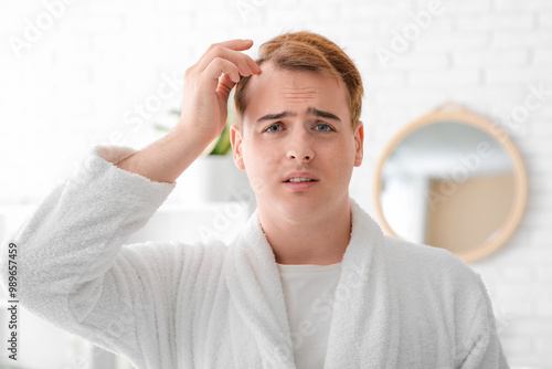 Worried young redhead man w...