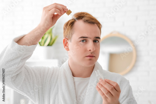 Young redhead man applying ...
