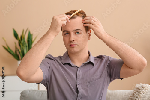 Young redhead man with hair...