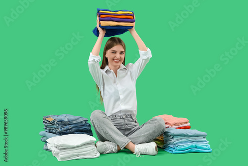 Young woman with stacks of ...