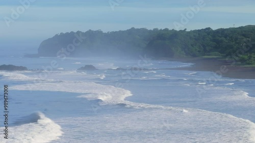 This breathtaking aerial shot showcases the stunning beauty of Playa del Ostional, with its lush, vibrant forests and mesmerizing azure waves located in the picturesque area of Santa Cruz, Costa Rica