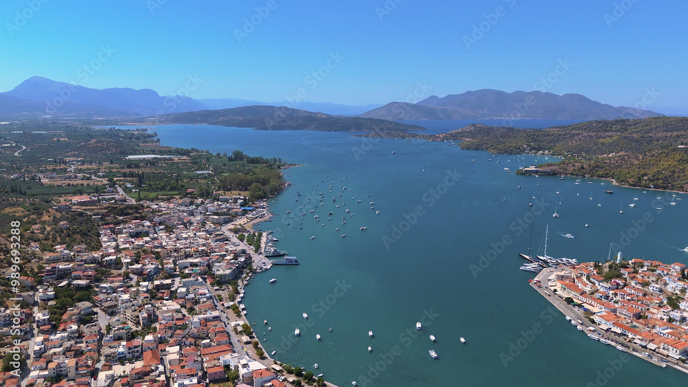Fototapeta premium greece peloponnese region poros island houses clock tower and boats aerial view on daylight