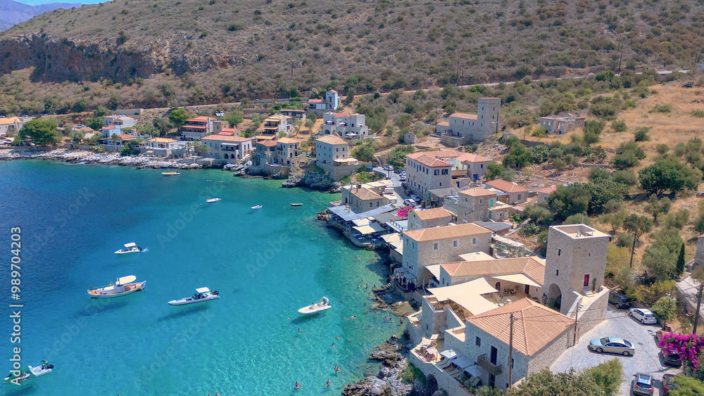 Greece Peloponnese Region Limeni Town Unique Blue Waters People Swimming in the Sea in Summer Holiday Concept and Boats Greece Peloponnese Region Limeni Town Unique Blue Waters People Swimming in the Sea in Summer Holiday Concept and Boats