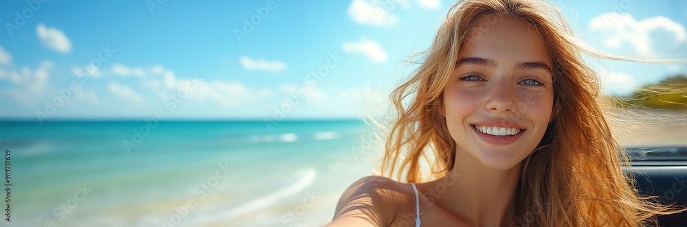 A smiling young woman enjoys a beach day, capturing a selfie against a vibrant ocean backdrop under a bright blue sky. A smiling young woman enjoys a beach day, capturing a selfie against a vibrant ocean backdrop under a bright blue sky.