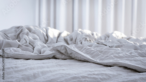 Unmade bed with rumpled white sheets in a bright room, conveying a cozy and relaxed atmosphere.