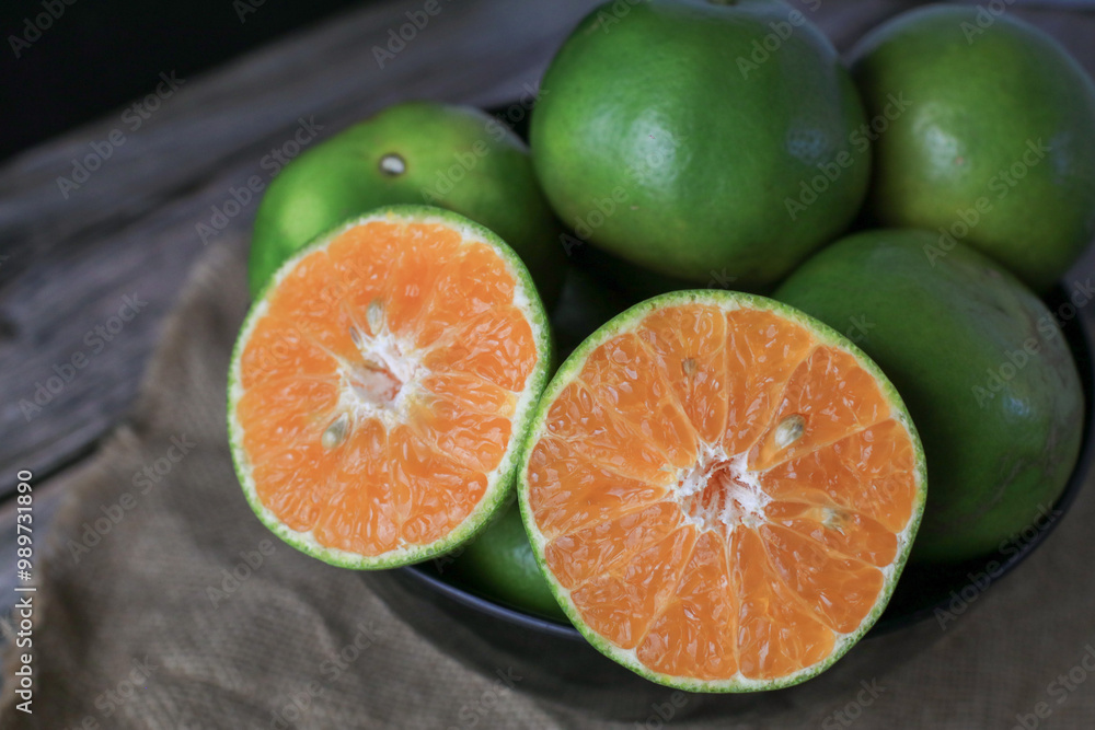 Fresh orange fruits on dark background. Citrus juicer. Summer tropical fruits. Food concept. Creative background Fresh orange fruits on dark background. Citrus juicer. Summer tropical fruits. Food concept. Creative background