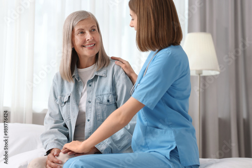 Healthcare worker supporting senior patient at home