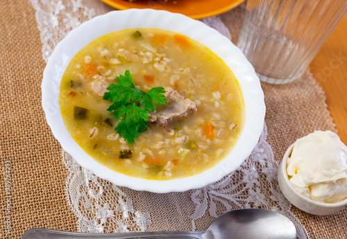 Traditional Russian soup rassolnik made from pickled cucumbers, pearl barley, and beef kidneys photo